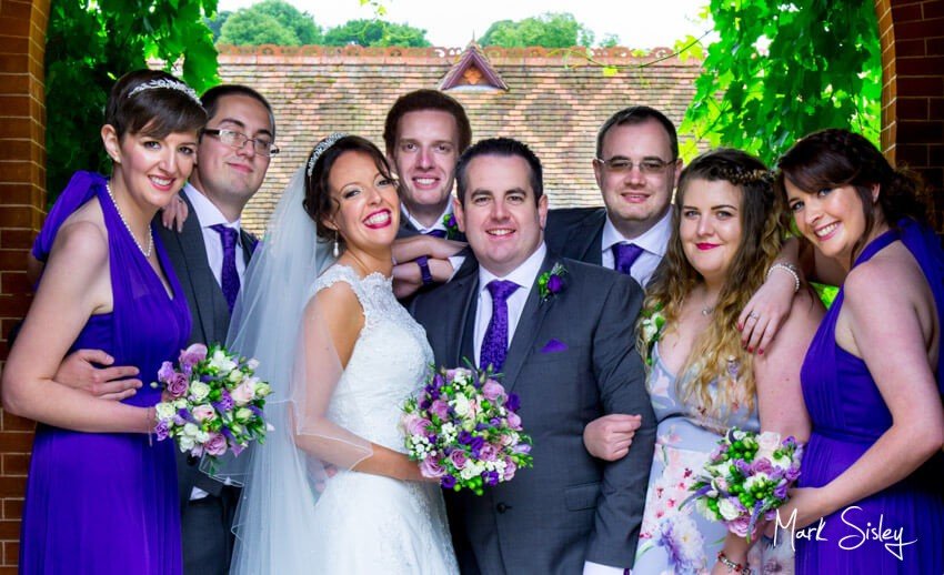 Bridal party in archway at The Dairy Waddesdon Manor - Mark Sisley Photography