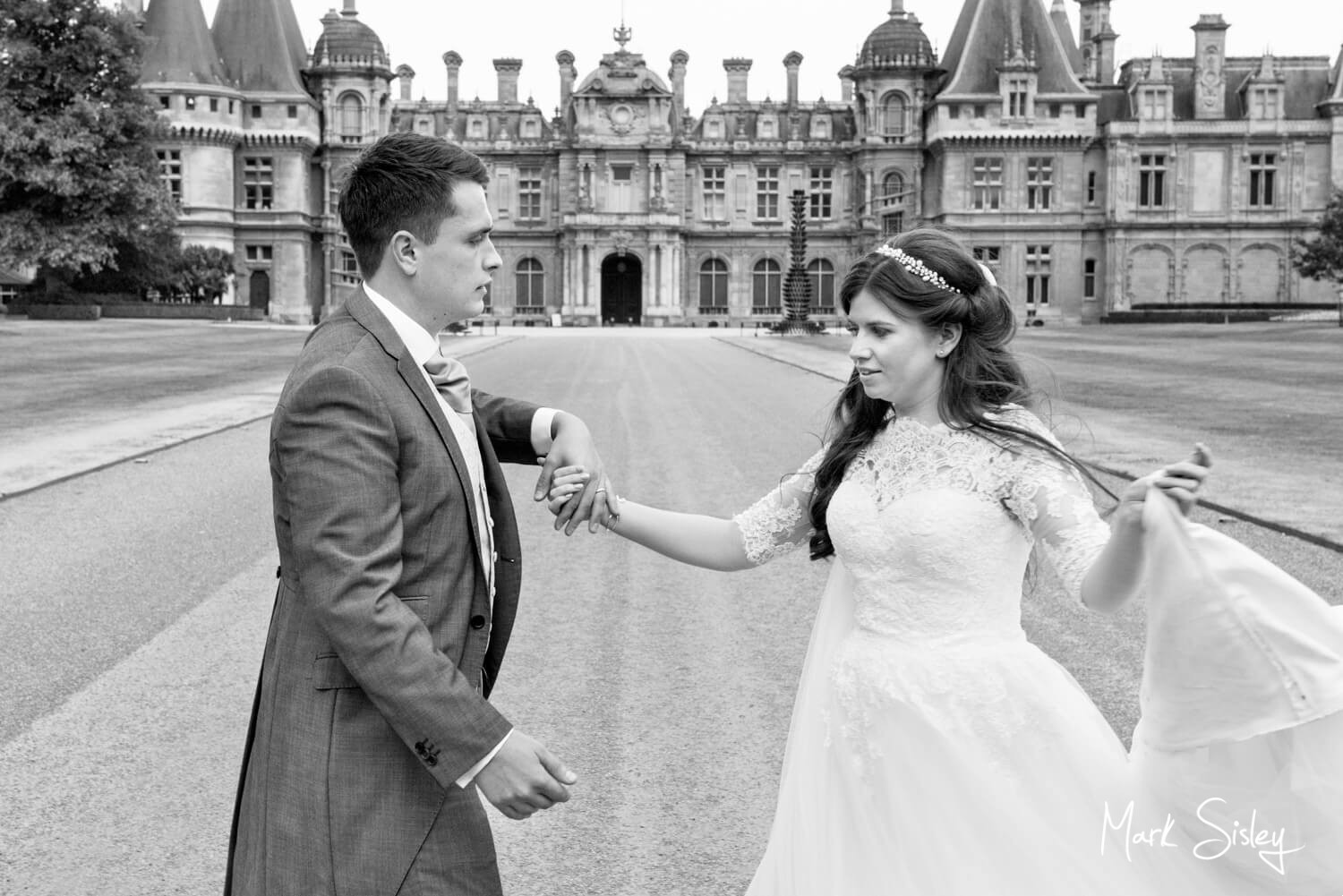 Bride and groom practicing their wedding first dance in front of Waddesdon Manor