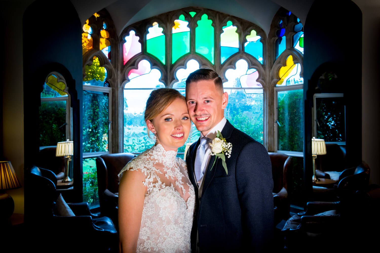 Missenden Abbey wedding pose in this stained glass window