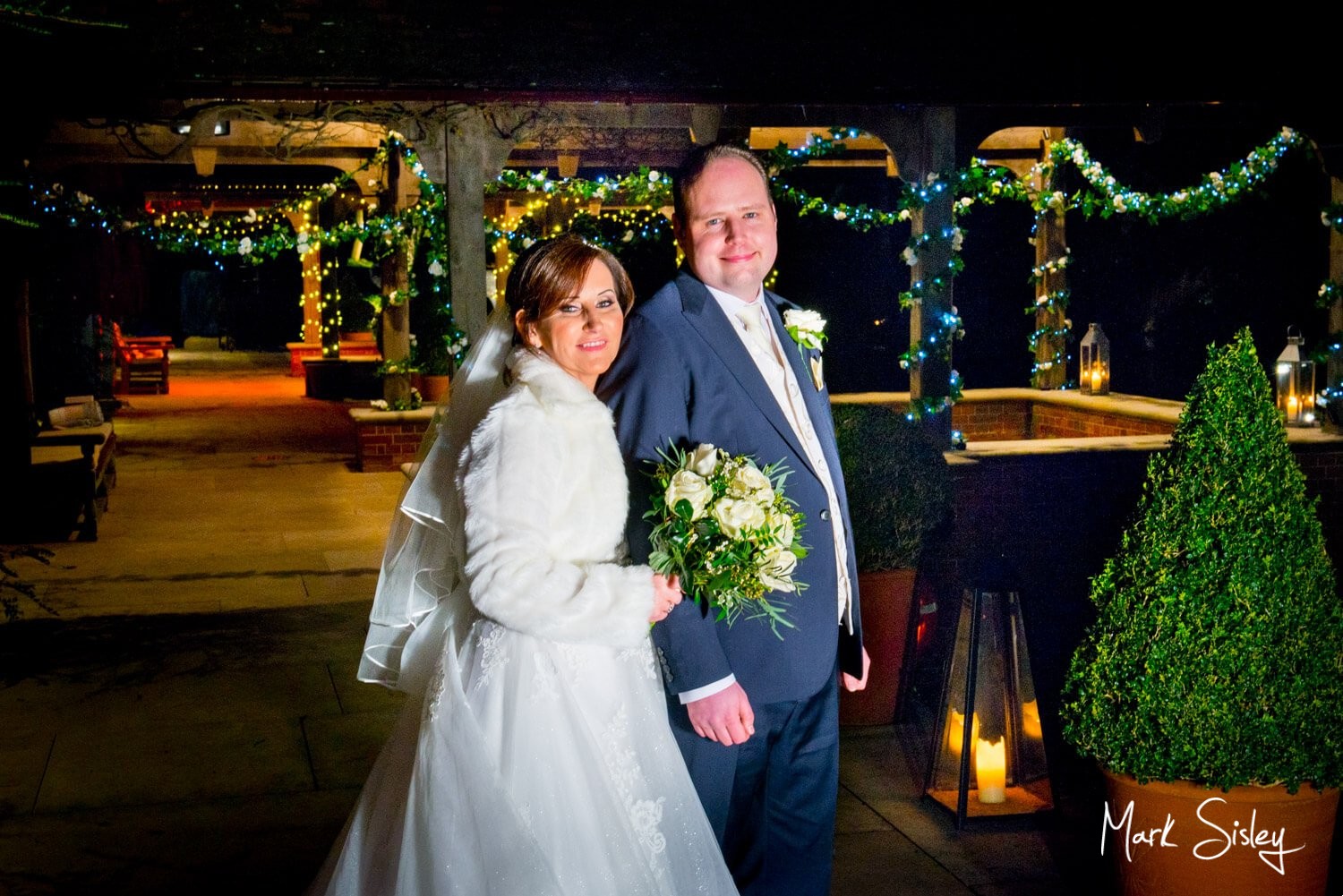 Waddesdon Dairy Christmas wedding with the pavilions lit by fairy lights