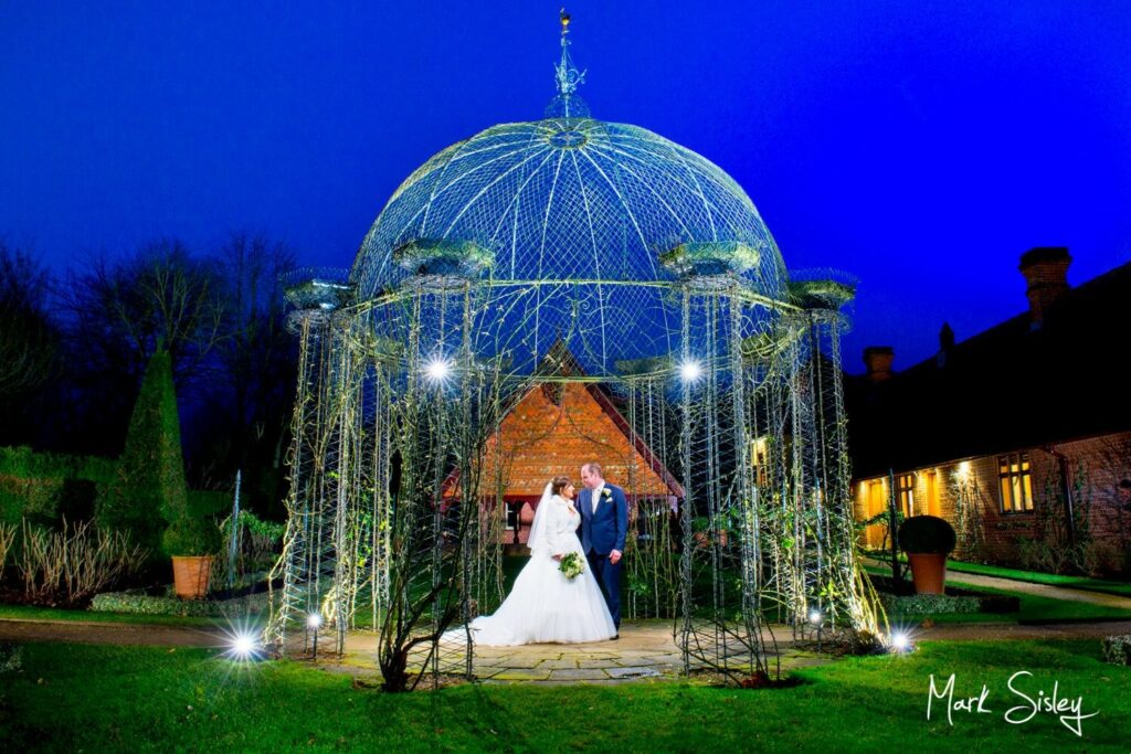 Waddesdon Dairy Christmas wedding pose after dusk with the rosary