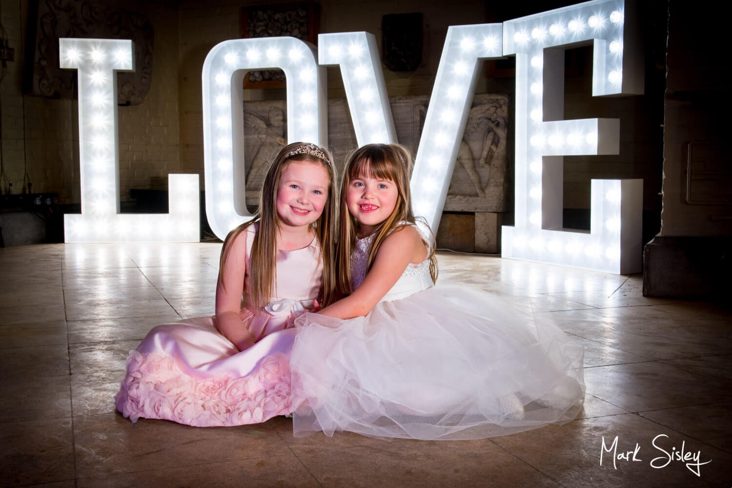 Waddesdon Dairy Christmas wedding pose by the uplighters