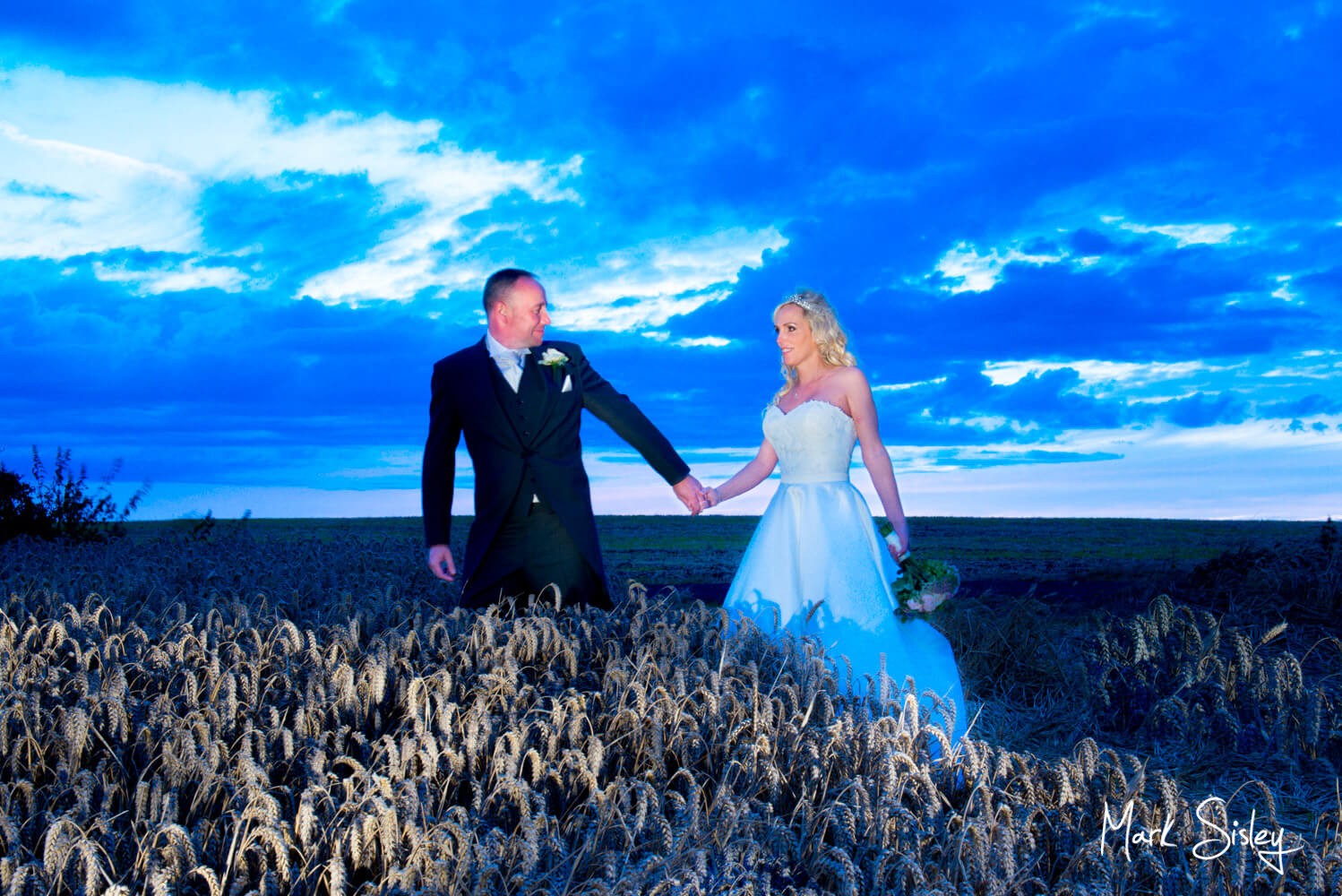 Notley Tythe Barn wedding in the wheat field at dusk