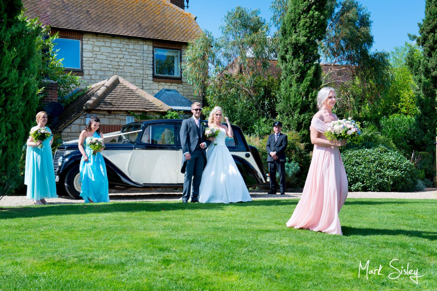 Bridesmaids arriving at ceremony at Notley Tythe Barn wedding