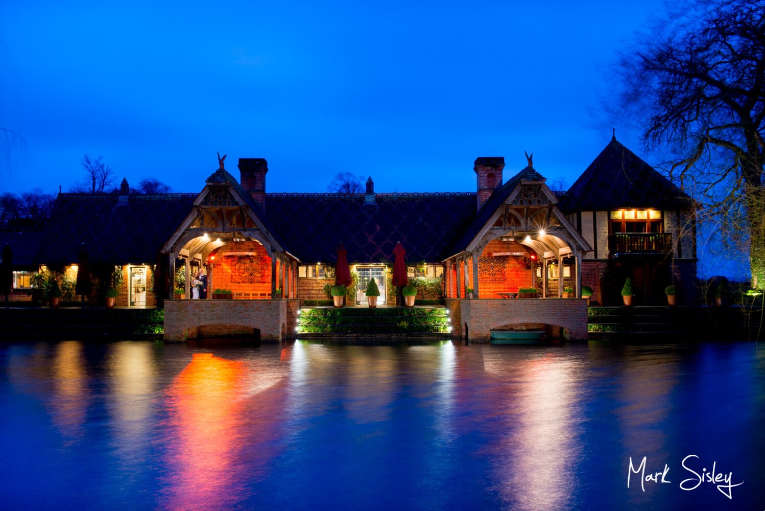 The bride & groom across the water for their Waddesdon Manor wedding during Storm Dennis