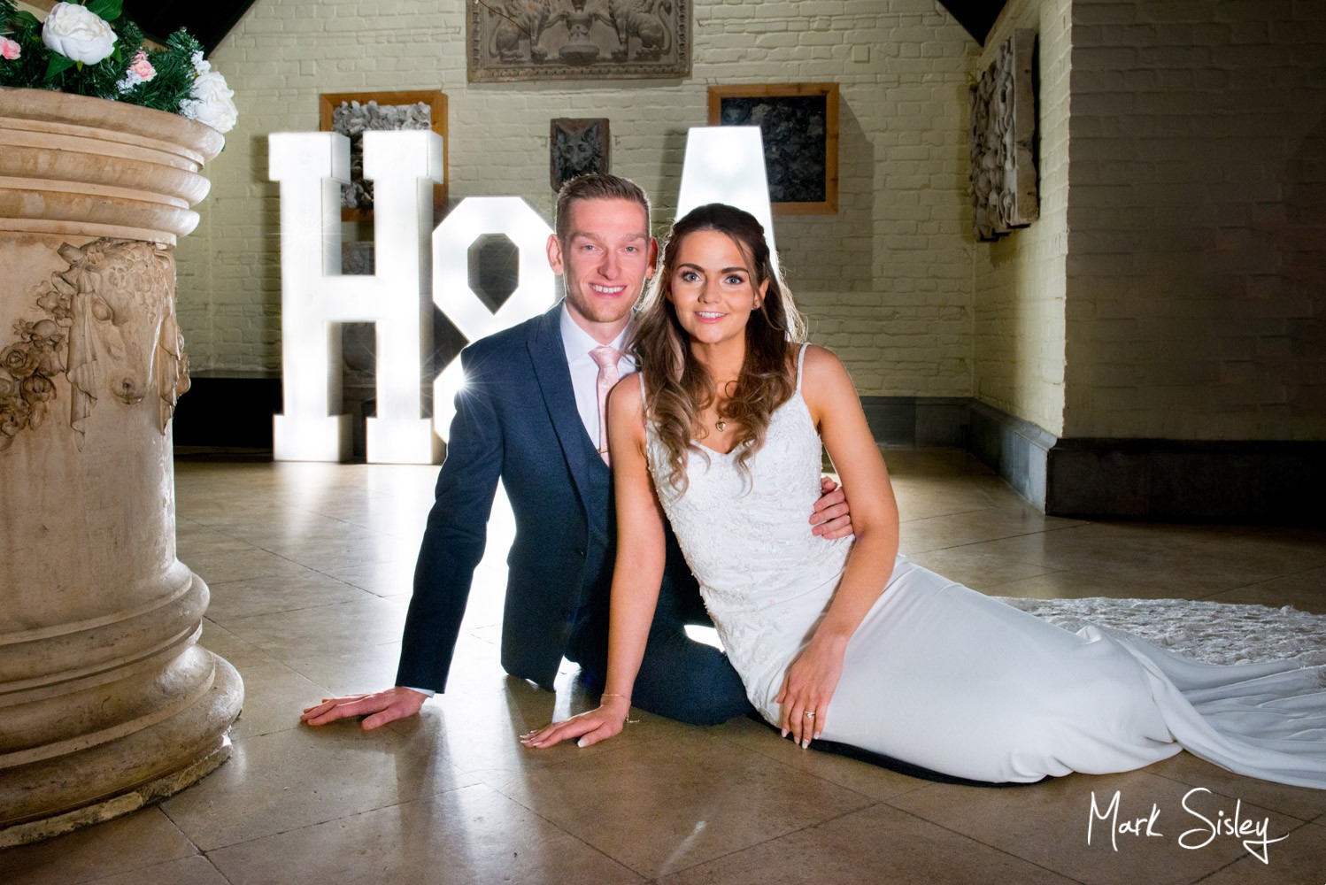 The bride and groom by the uplighters for their Waddesdon Manor wedding during Storm Dennis