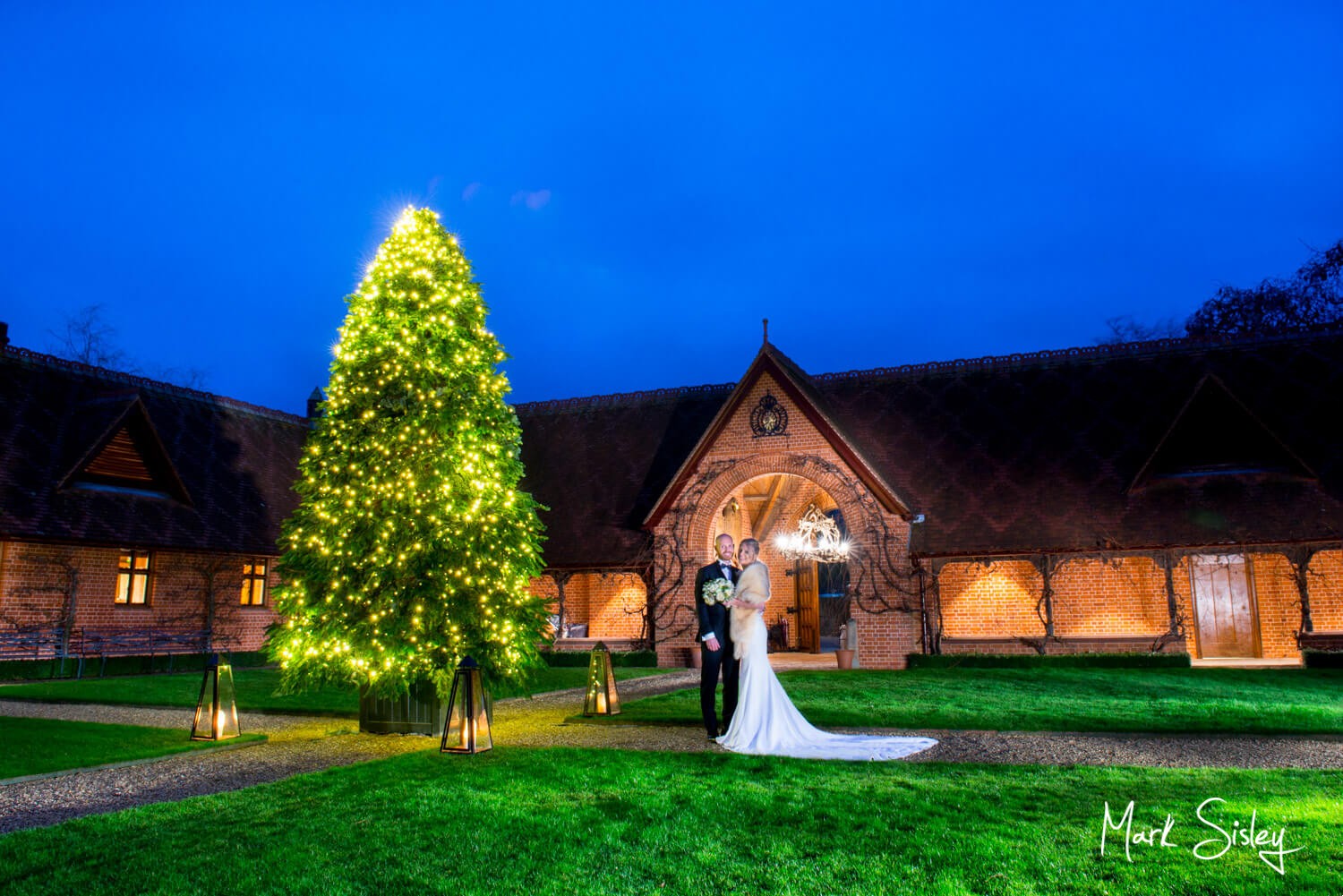 Waddesdon Dairy winter wedding pose by the Christmas tree