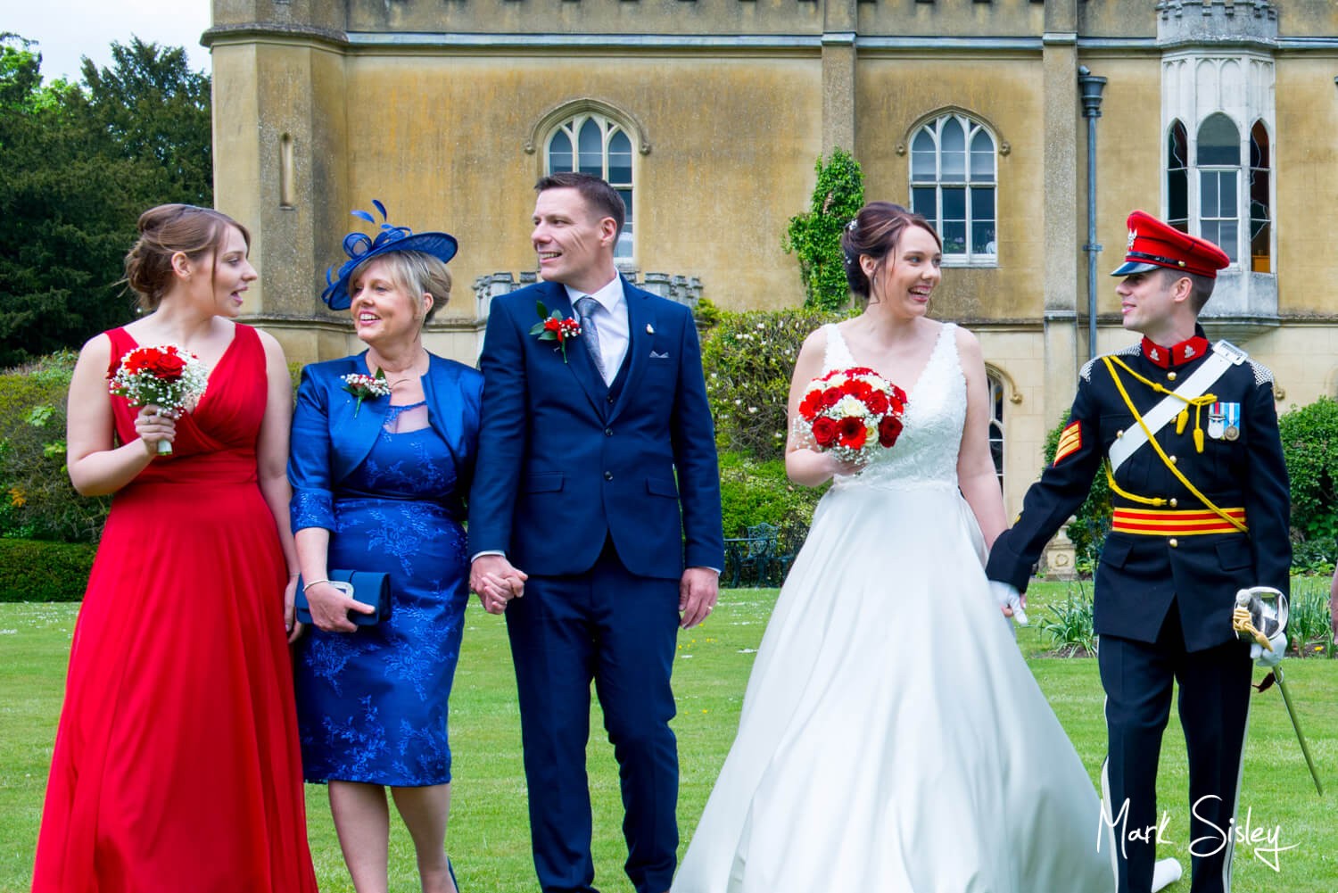 Taking a stroll on the lawns at this Missenden Abbey military wedding