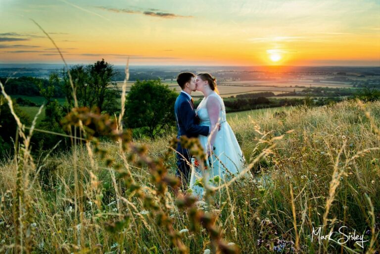 The newlyweds pose for a sunset shot at a local beauty spot on their wedding day at The Mercure Lambert Hotel, Thame 
