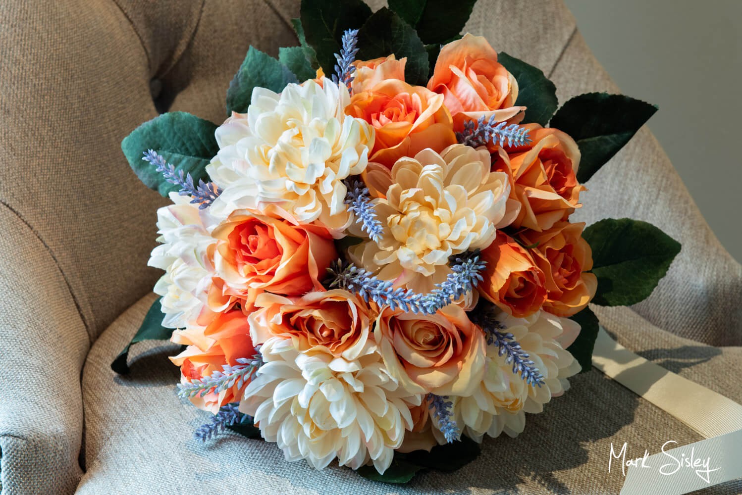 The bride's bouquet placed on a chair just prior to her wedding at the Lambert Hotel near Thame in Oxfordshire