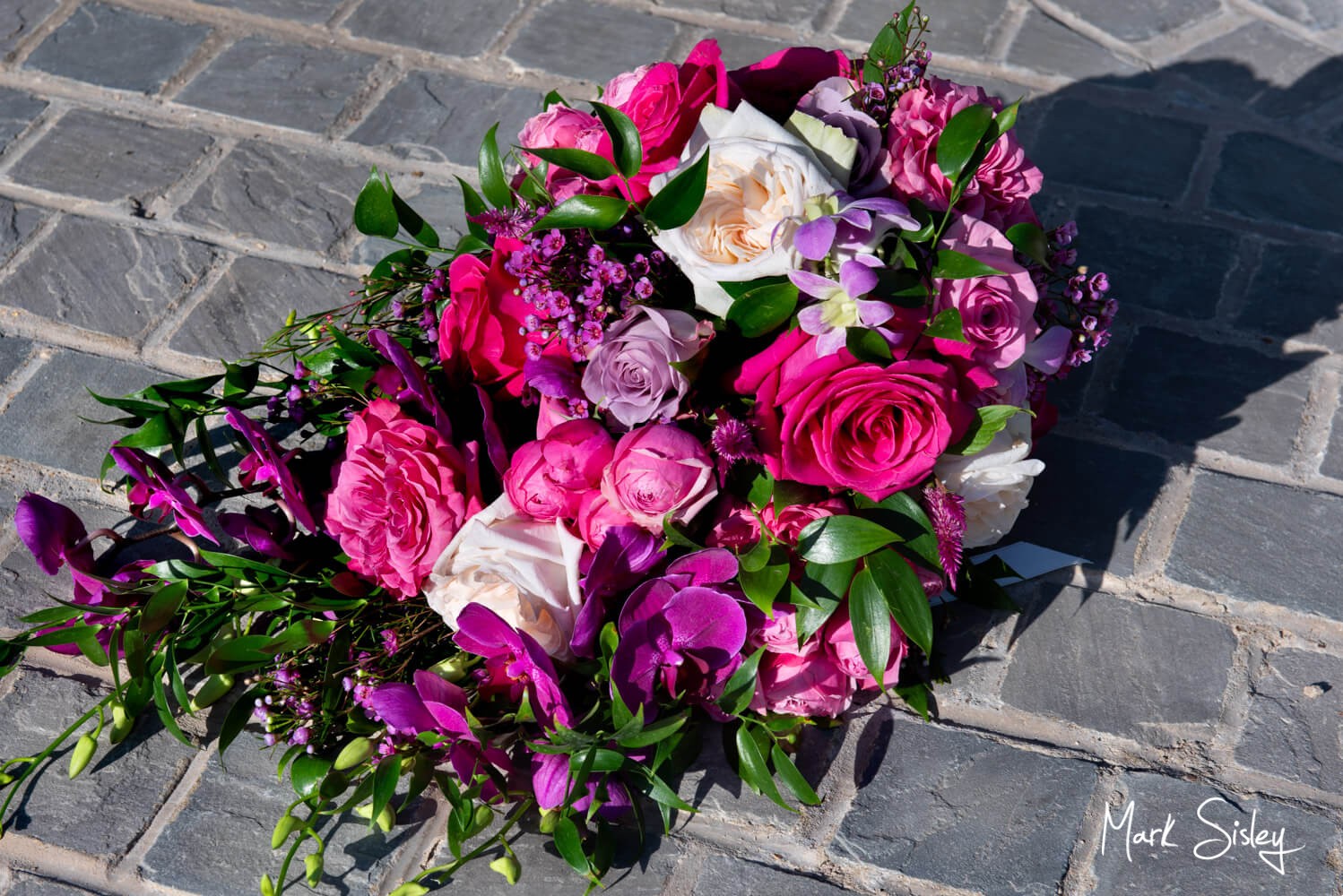 Rackleys Barn Wedding Photography (29) The bride's colourful wedding bouquet captured on the cobblestones at Rackleys Barn