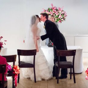 Bride and groom kissing during ceremony at Stoke Place wedding