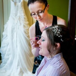 Bride having her hair and makeup done at Stoke Place wedding