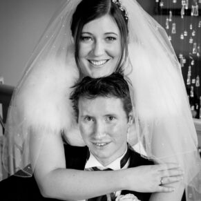 Black and white image of bride and groom hugging at Stoke Place wedding