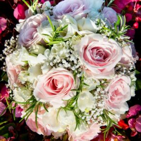 Close-up image of bridal bouquet with soft pink roses, gypsophilia, rosemary and white freesias at Taplow House Hotel wedding