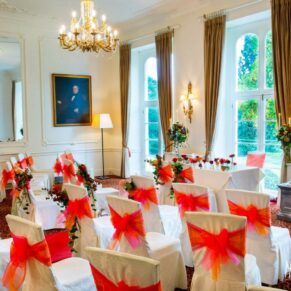 Taplow House Hotel photography of the prepared for wedding ceremony with orange and red flowers