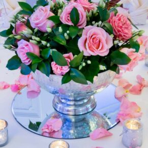 Pink roses in footed vase for a wedding at Taplow House Hotel