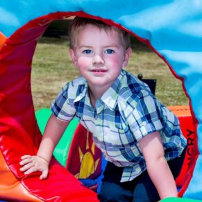 Fun informal image of little boy playing at Taplow House Hotel wedding