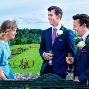 Cliveden House wedding images of the guests enjoying a chat on the hotel terrace