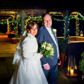 Waddesdon Dairy Christmas wedding pose by the pavilions after sundown