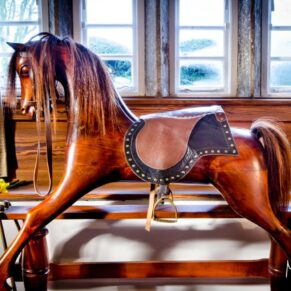 UK Holiday homes photography - rocking horse in the window in the Yorkshire Dales
