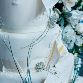 The divine white wedding cake decorated with coordinating delicate flowers