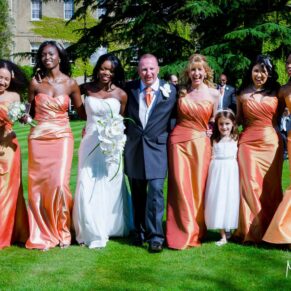 Vibrant colours and wonderful sunshine for this natural bridal party walking shot captured in the gardens of this Old Windsor wedding venue 