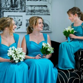 The bridesmaids chatting before the ceremony in the grand entrance area at this Beaumont Estate wedding 