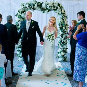 The happy newlyweds exit their civil wedding ceremony watched by their nearest and dearest at their Beaumont Estate wedding 
