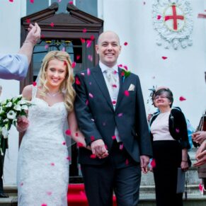 The happy newlyweds walk through their colourful confetti aisle outside the the White House at their Beaumont Estate wedding  