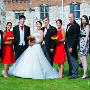 Bridal party group pose captured at the front of the abbey