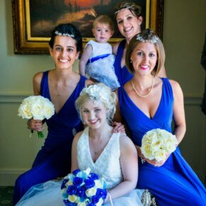 Pre ceremony pose of the bride with her colourful bridesmaids