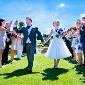 The newlyweds walking through their reception aisle soon after their civil ceremony