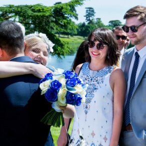 The bride hugging her friends during the drinks reception on the terrace
