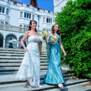 The bride taking a stroll down the garden steps with her bridesmaid at her Danesfield House wedding