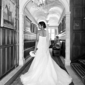 The bride showcasing the back of her stunning gown in the venue's grand corridor 