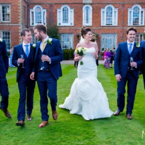 The newlyweds taking a stroll with their friends whilst Dorton House is in the background