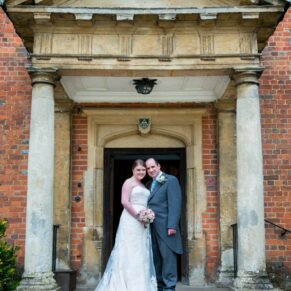 The newlyweds in the grand entrance doorway at their Dorton House wedding 