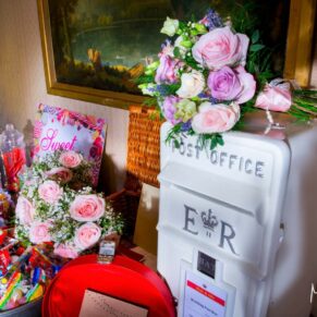 The wedding gift table and flowers captured with some dramatic lighting at Hartwell House 