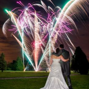 A grand fireworks finale including the bride and groom in the foreground for their Hedsor House wedding day celebrations 