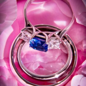 Wedding rings placed on a delicate pink rose at Hedsor House 