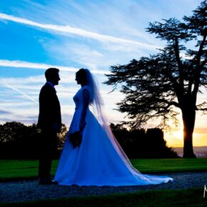 The bride & groom silhouette captured against a dramatic sunset for this autumnal wedding 
