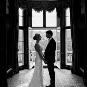 A silhouette shot of the newlyweds in a feature window on the Latimer Estate 