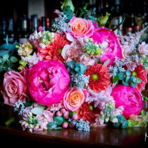 A gorgeous and vibrant floral arrangement captured with window lighting at this Le Manoir Aux Quat Saisons wedding 
