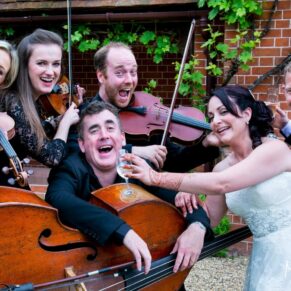 Even the musicians joined in for a fun pose at this lively wedding reception 