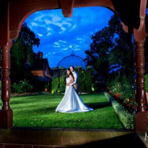The newlyweds captured at dusk with my floodlighting through one of the archways of the Buttery at The Dairy
