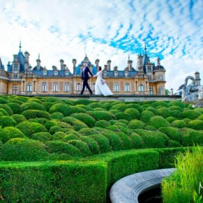 The newlyweds take a stroll hand in hand along the Parterre at Waddesdon Manor under dramatic skies 