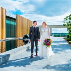 The smiling couple walk towards the camera at Windmill Hill on the Waddesdon Estate