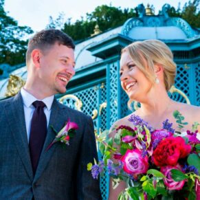 The smiling newlyweds take a stroll in front of the Aviary up at Waddesdon Manor