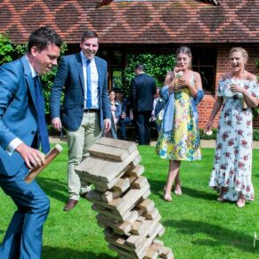 Jenga action shot with fabulous guest reactions at this fun filled wedding held at The Dairy